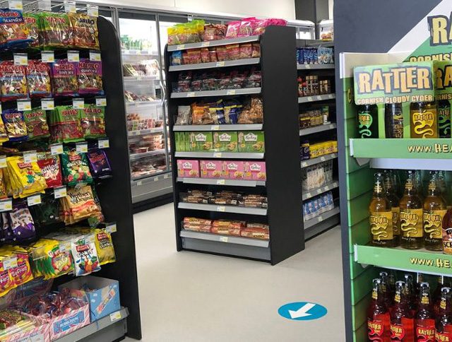 Interior of the Monkey Tree Holiday Park supermarket with shelves stocked with snacks, drinks, and groceries.